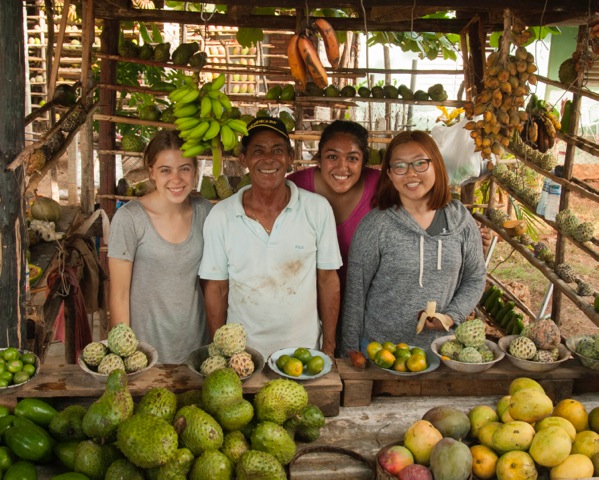 Alice, Zara, and Abby at a fruit stand where we devoured the most delicious mangos we had ever tasted and some of us tried soursop for the first time. (Photo by Britt Basel)
